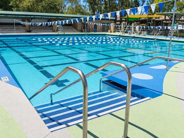Resurfaced pool deck and surrounding surfaces in Santa Fe Springs, CA