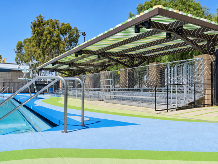 Six colors in the water flow pattern at the Santa Fe Springs aquatic center pool deck